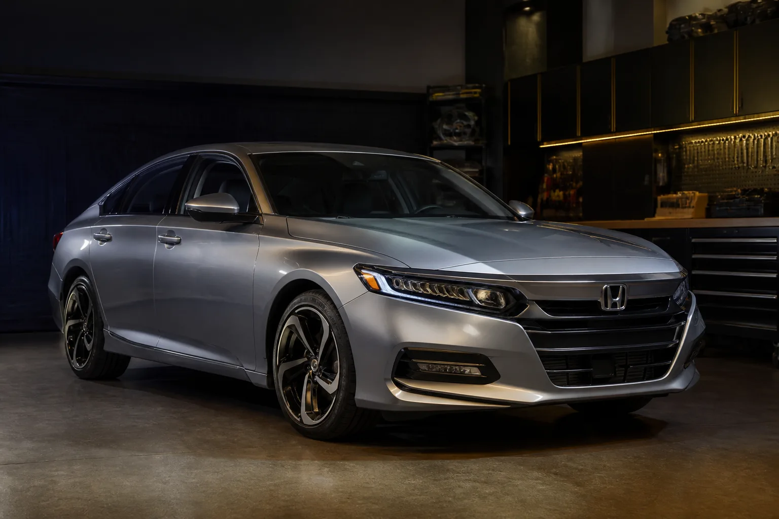 Silver Honda sedan parked in a workshop bay