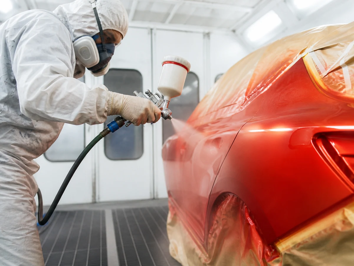 Car bodywork and paint spraying in a professional booth